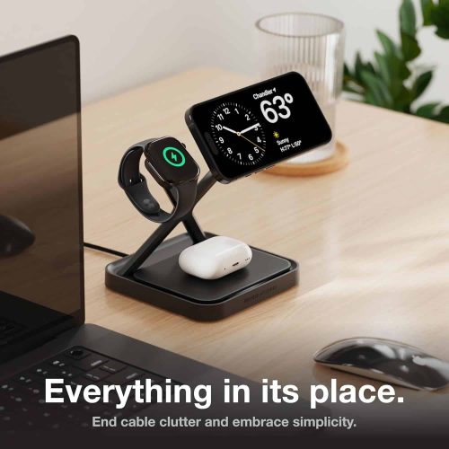 NOCO XDS3B wireless charging stand in matte black charging an iPhone, Apple Watch, and AirPods on a desk.