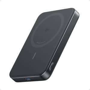 Anker MagGo Power Bank (Qi2) attached to an iPhone on a modern workspace desk